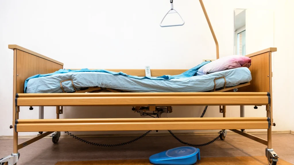 Electric home care bed in a house bedroom for patient care.