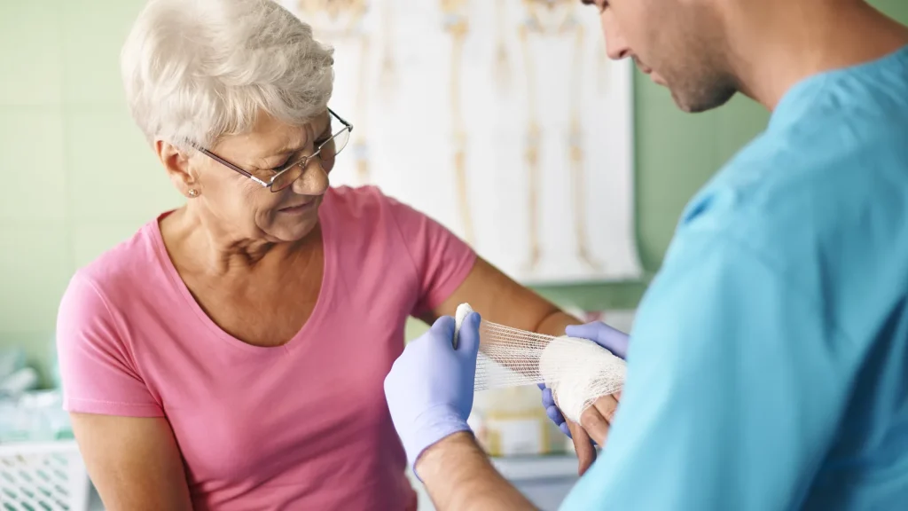 Nursing wound care at home with clean dressings and materials.