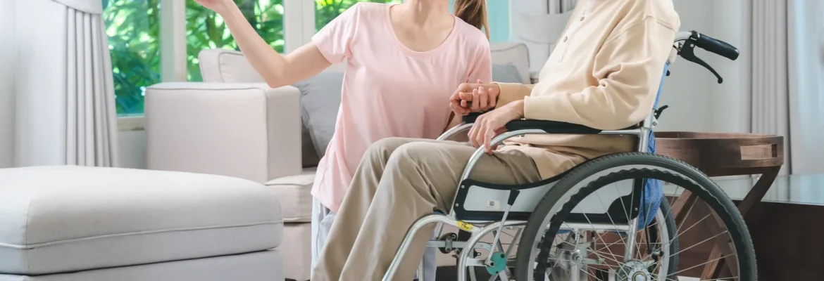 Wheelchair in a home environment next to a patient's bed.