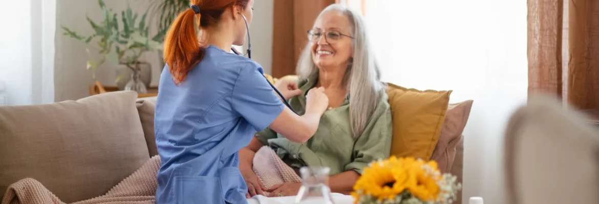 Nurse providing home care to a patient in the presence of family.